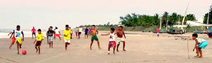CHILDREN PLAYING FOOTBALL IN GUIJIRU BEACH